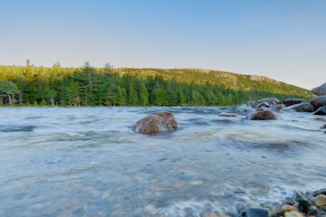 Large Pink Granite boulder sits in the rough waters of Jordan pond on a very windy morning