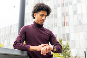 Black man checking time on wristwatch
