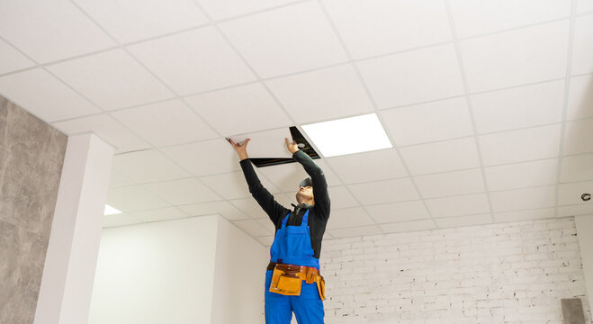 Ceiling installation with expert technicians In the room that is in the construction process.