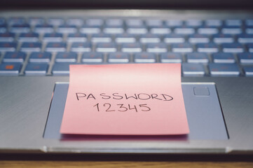 Easy Password Concept on computer keyboard. Password 12345 on pink sticky note