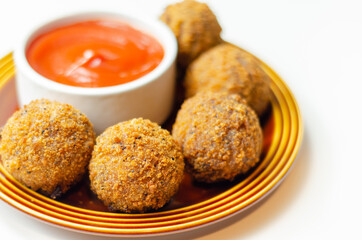 Southern fried chicken bites with tomato dip, chopped and shaped chicken breast with coated in southern fried seasoned breadcrumbs