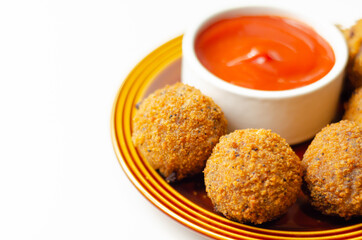 Southern fried chicken bites with tomato dip, chopped and shaped chicken breast with coated in southern fried seasoned breadcrumbs