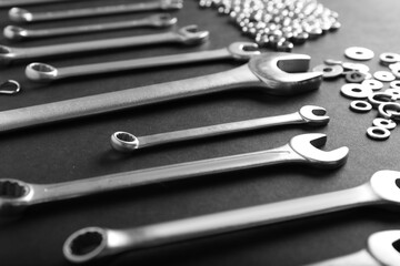 Metal nuts and bolts close up on black background