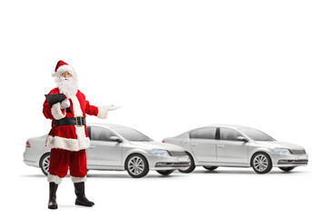 Full length portrait of santa claus presenting new silver cars