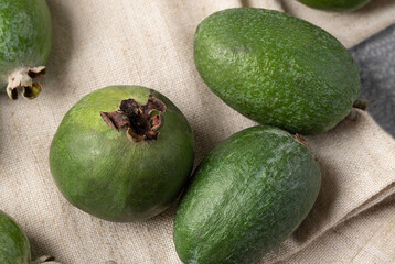 top view of three green feijoa berries of different shapes. Tropical fruit for smoothies, juices and jam.Acca sellowiana for detox smoothie ingredients