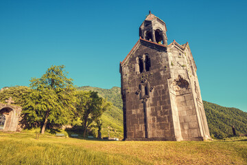 Fototapeta na wymiar The chapel and bell tower stand alone on the territory of the Haghpat Monastery in Armenia. Sightseeing and pilgrimage concept