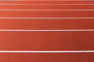 Solid, straight white lines of all weather rubber athletics running track.
