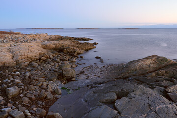 Fototapeta na wymiar Exposed rocks and barnacle at low tide on St. George Island at sundown with a slow exposure