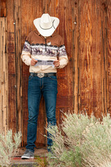 Tonopah, Nevada, US - May 18, 2011: Closeup of sheriff in cowboy fashion clothes against brown...