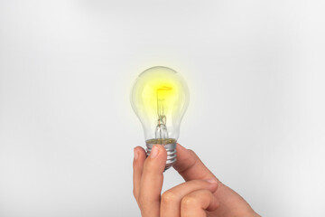 Decision making concept. New idea. Light bulb in the hands of a man.