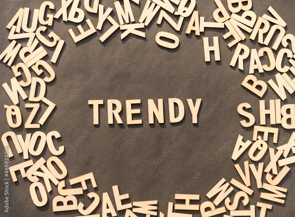 Fototapete trendy word in wooden cube alphabet letters top view on a rustic paper background.