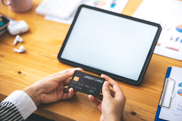 young woman holding credit card and using a laptop computer business woman working from home, online shopping, ecommerce, internet banking, spending money, finance, work from home concept..