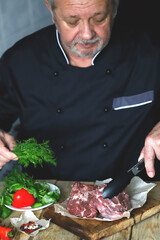 Soft focus. The chef prepares raw lamb meat.