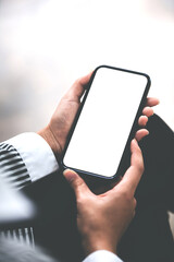 Cropped image of a female freelance translator's hand. holding a blank screen smartphone in his modern workplace