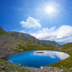 Fototapeta na wymiar small blue lake in mountain valley at the sunny day