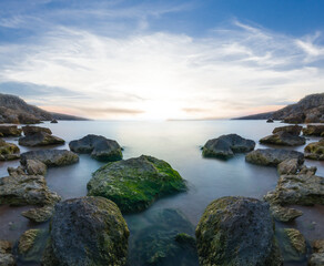 quiet sea beach with huge stones at the early morning