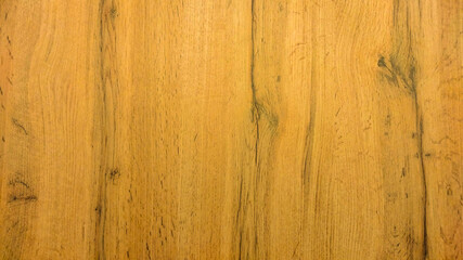 Obraz premium The wooden texture is yellow with vertical lines. Wooden surface.