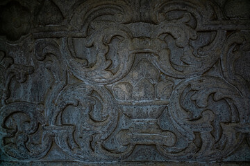 Fototapeta na wymiar Patterns on the stone. Decor on an old wall in the Crimea