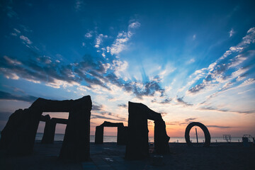 Abandoned Kazantip beach in the village of Popovka, Crimea, Russia. Beautiful sunset. The silhouettes of the stone gates imitate the ancient ones. The best place for trance and techno parties