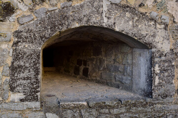 An embrasure for shooting in the thick wall of an old fortress or castle