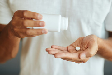 Close-up of man takes a medicine.