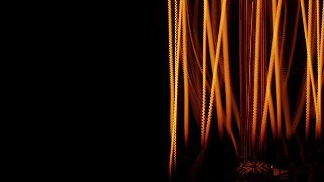 Tungsten. One of the most refractory metals in the universe. The decorative warm light bulb rotates smoothly. Super macro video.