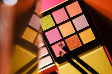 Eyeshadow Palette with bright, metallic, and matte shades at colorful background - obrazy, fototapety, plakaty