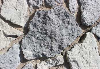 Stone with a crack in the wall in a gray tint