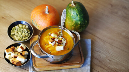 Delicious pumpkin soup in a saucepan.