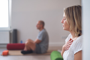Close-up of a woman breathing during a yoga class.