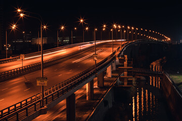 Bridge in the night city,  long exposure photography, reflections of lantern lights in the water