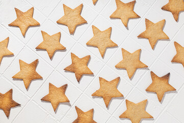 Pattern of gingerbread cookies in the form of stars on a white background