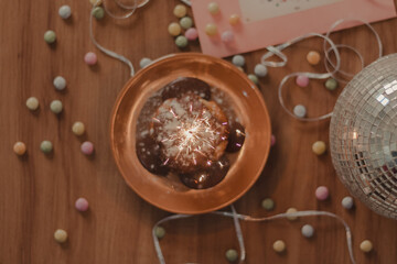 cupcake with a spark candle in a birthday table
