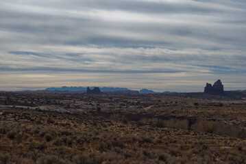 Plains of Utah with rock formations and mountains in the distance