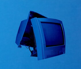 Broken TV set over blue