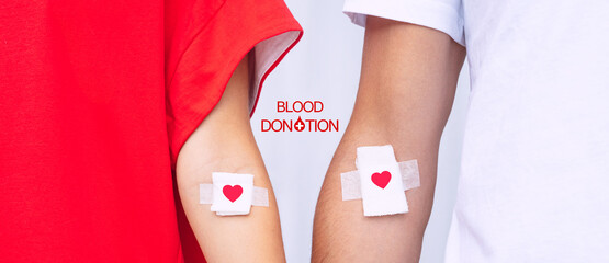 Blood donors with bandage after giving blood. Blood donation, save lives. World blood donor day concept - obrazy, fototapety, plakaty