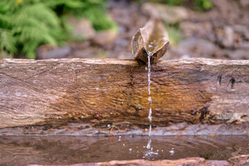Wooden source of spring outdoors.