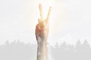 Double exposure of human hand with peace symbol. Ecology concept against climate change.