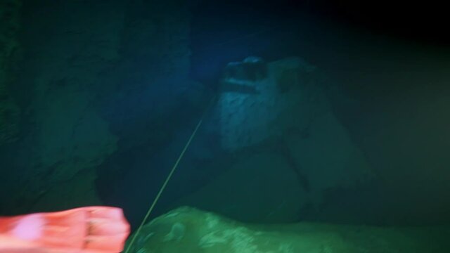 Budapest - 17 August 2017: Technical diver in red flippers in the underwater cave of Budapest