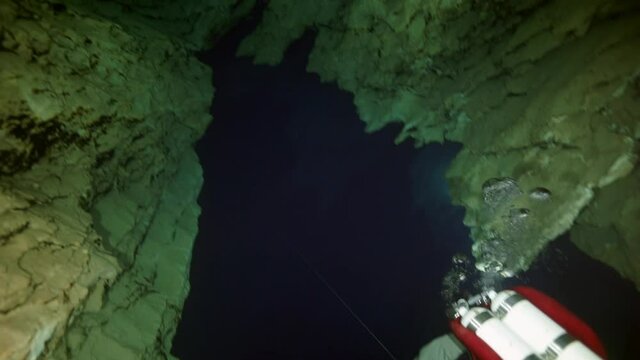 Budapest - 17 August 2017: Technical diver in red flippers in the underwater cave of Budapest