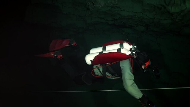 Budapest - 17 August 2017: Technical diver in red flippers in the underwater cave of Budapest
