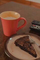 mug of coffee and a pice of chocolate brownie for breakfast