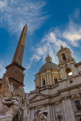 Fototapeta na wymiar Obelisk in Piazza Navona with cathedral in the background