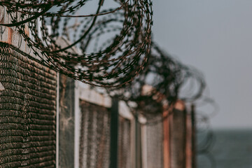 Barbed Spheres - a fence topped with barbed wire