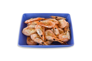 Cooked fresh shrimps on a blue plate isolated on white background. Seafood healthy food
