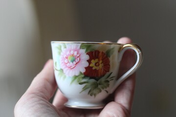 Tiny teacup in a hand closeup