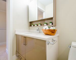 Fragment of luxury bathroom with a sink and wooden cabinet