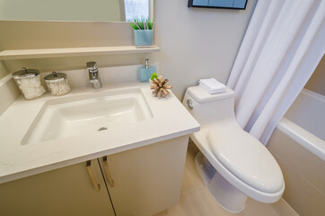 Fragment of luxury bathroom with a sink and wooden cabinet