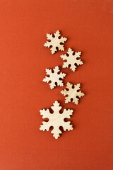 christmas themed background with wooden snowflake shapes on fabric
