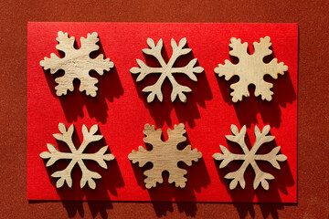 christmas themed background with wooden snowflake shapes